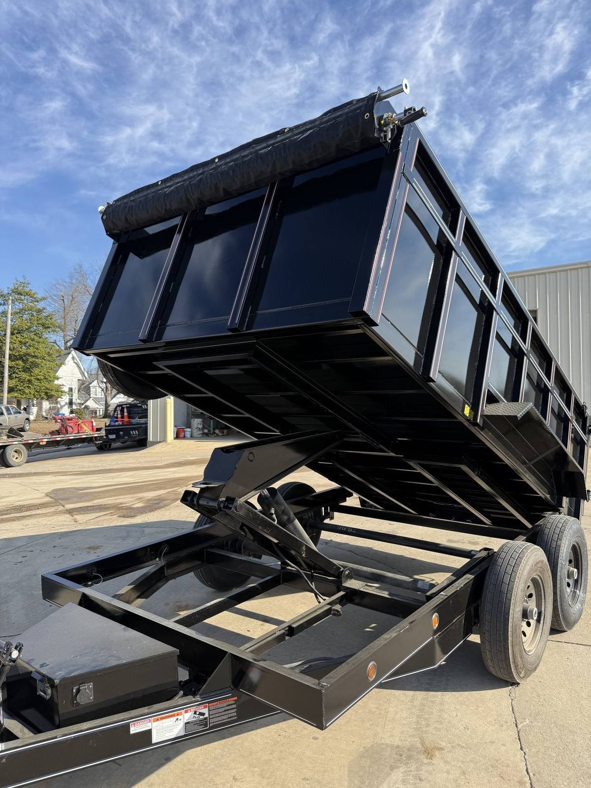 Triple R dump trailer dumping with the bed fully raised