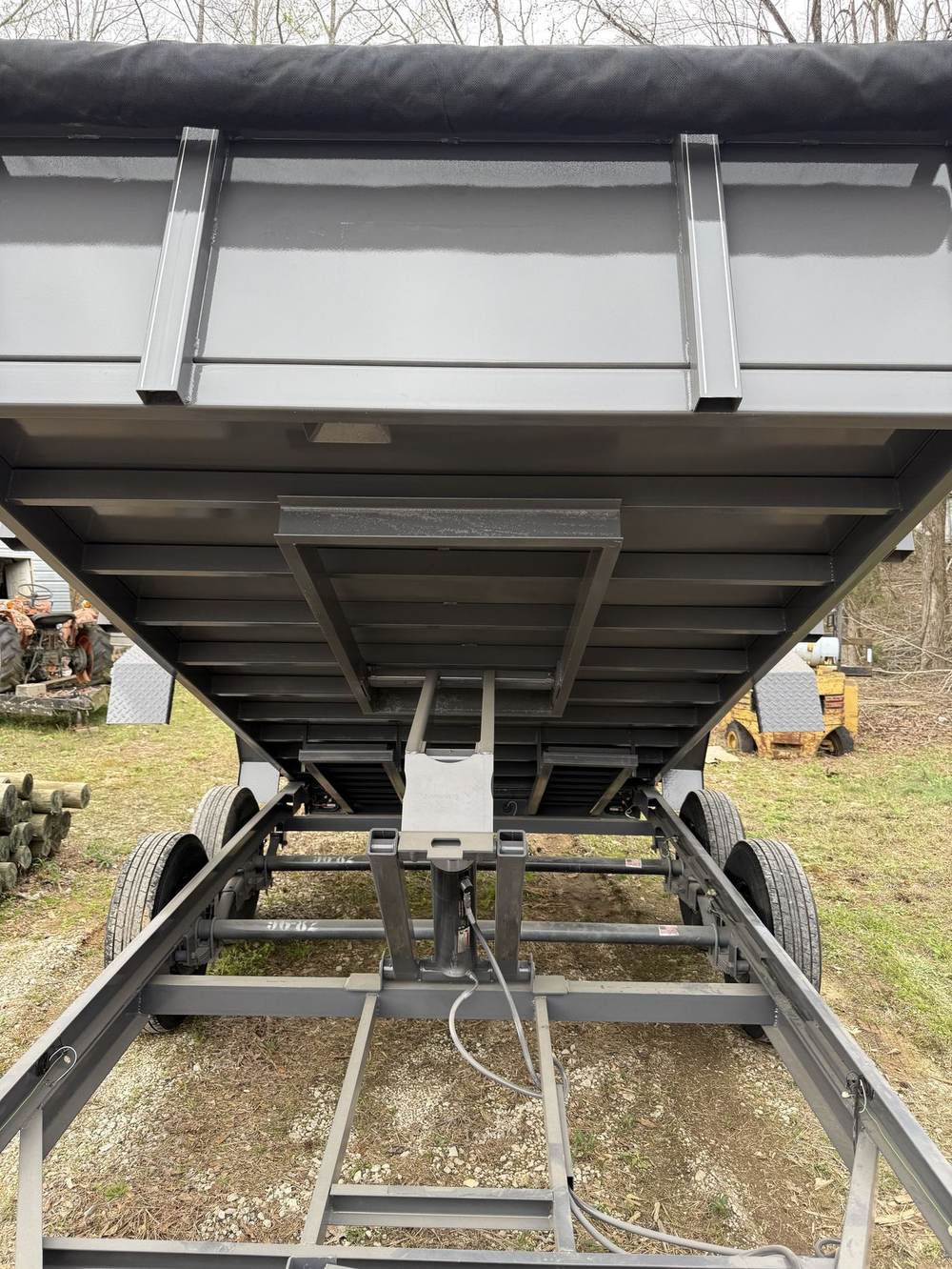 Scissor hoist under a raised Triple R dump bed