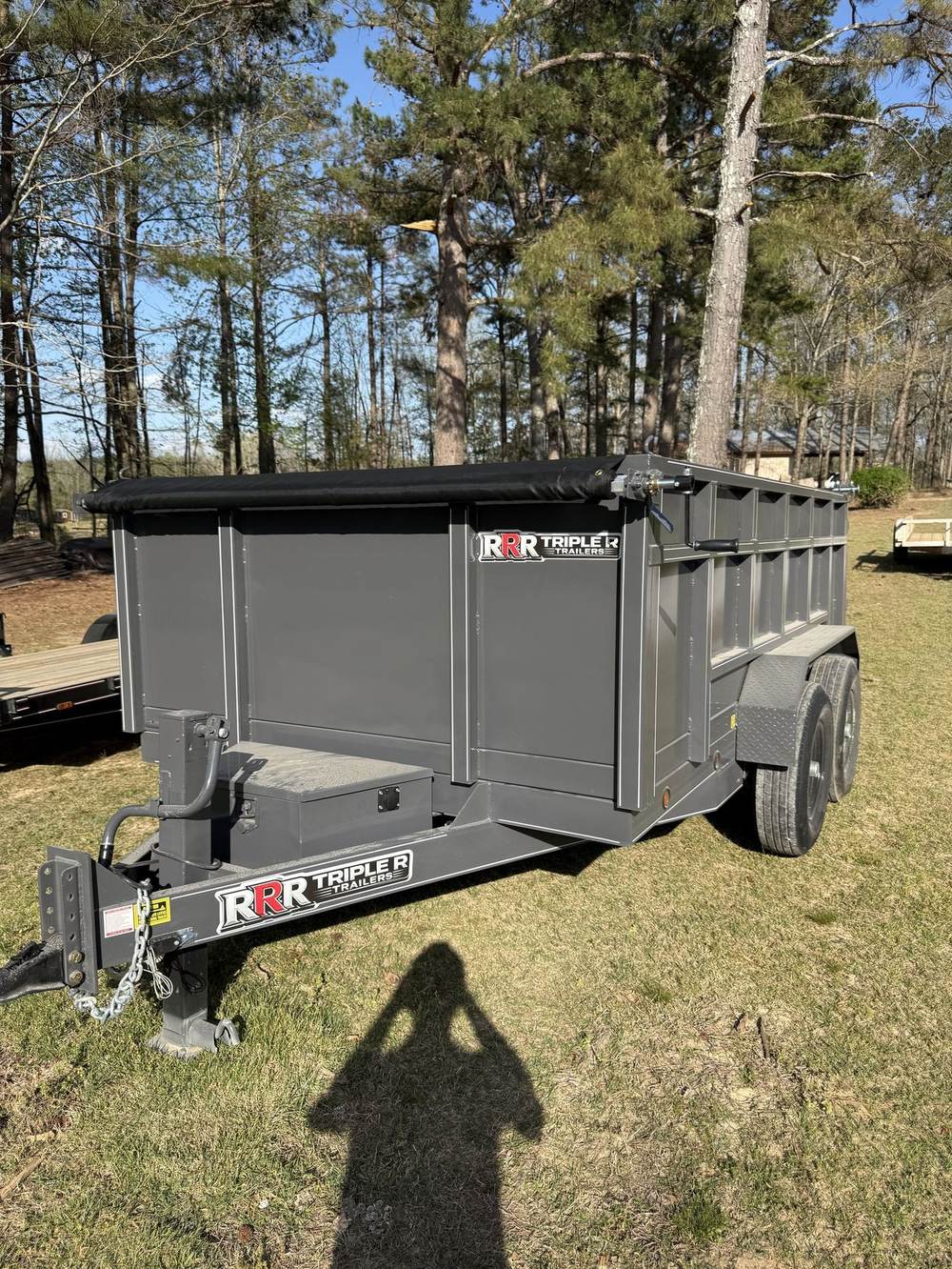 Gray Triple R dump trailer wearing the RRR decal outside the factory