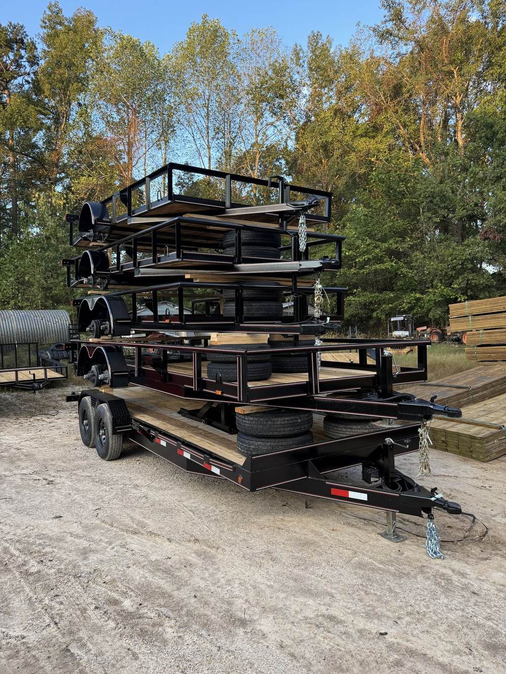 Stacked utility trailers awaiting dealer pickup